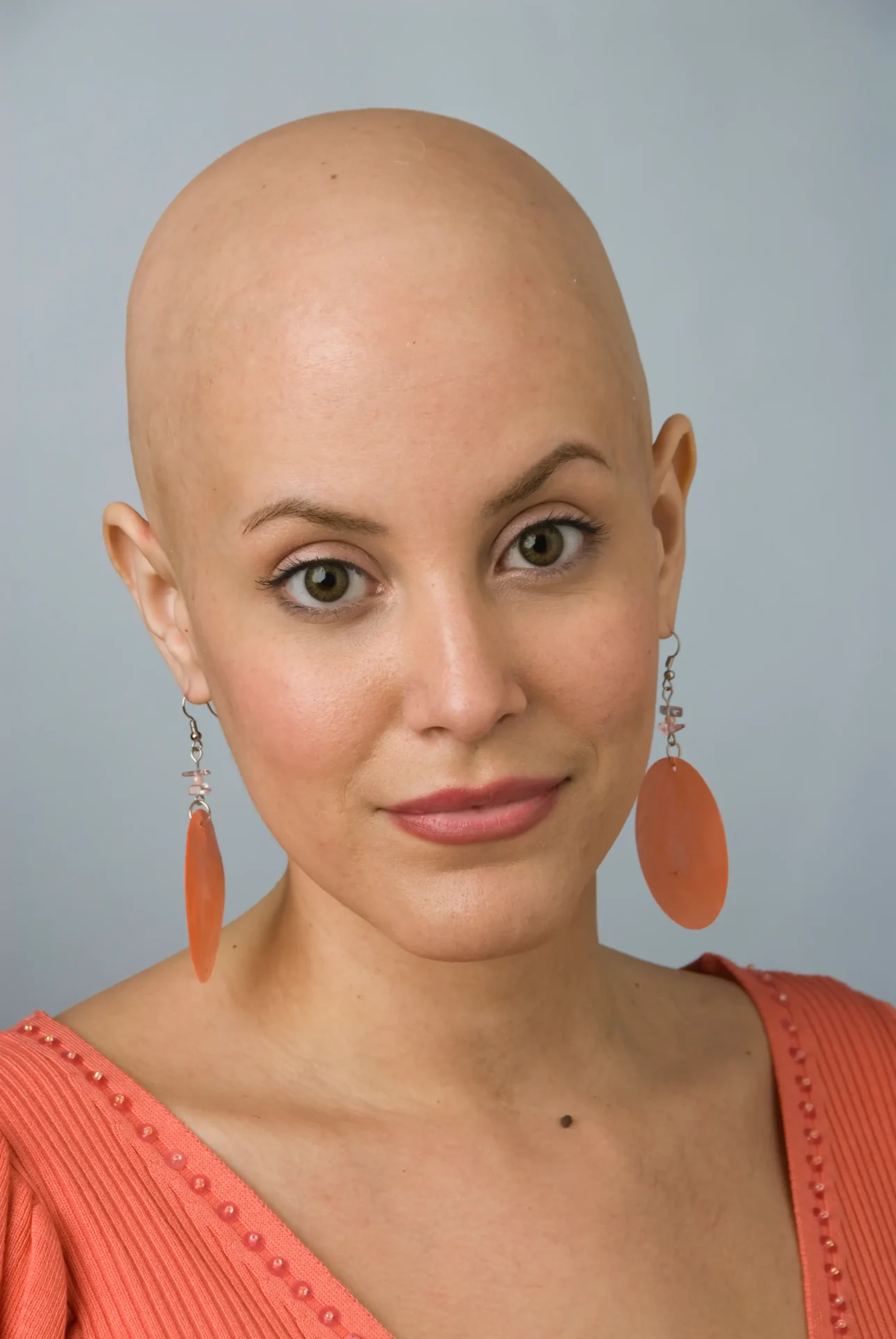 A Bald Woman in an Orange Color Outfit