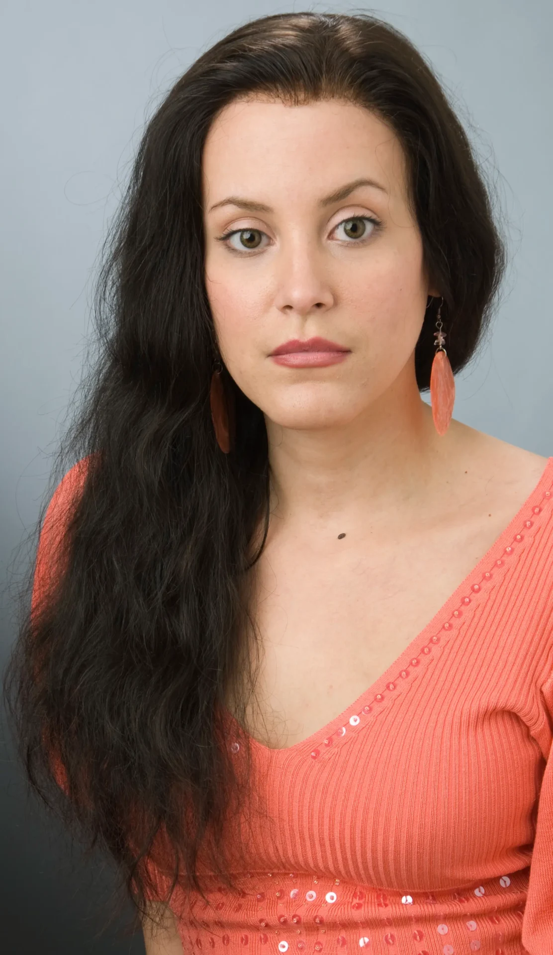 A Woman in an Orange Color Outfit With Dark Hair